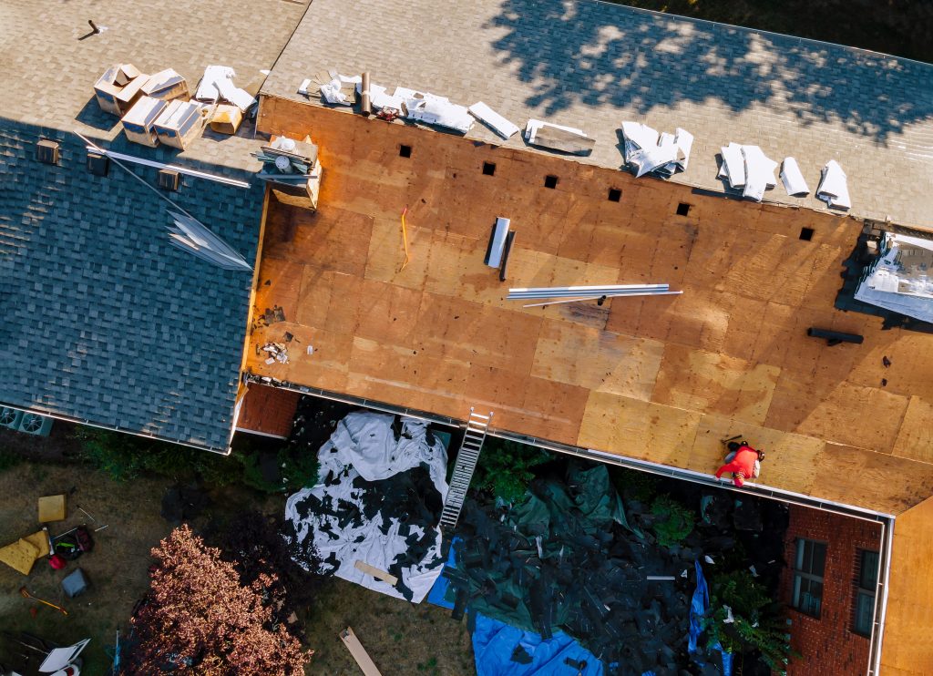 A roof replacement in progress with roof decking visible, leading to the question "What is roof decking?"